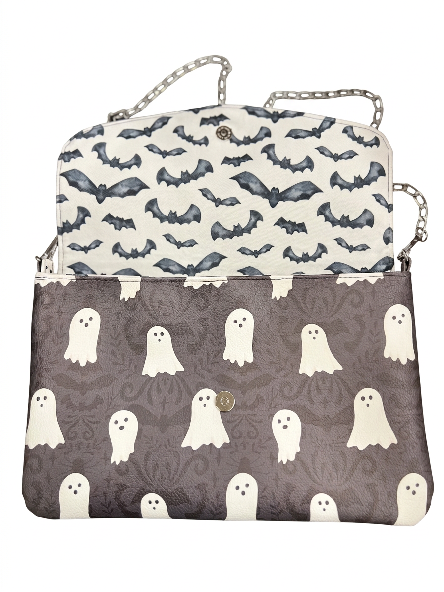 Boo After Dark ghost-print envelope bag open to reveal dark bats on cream flap lining and a magnetic snap closure.